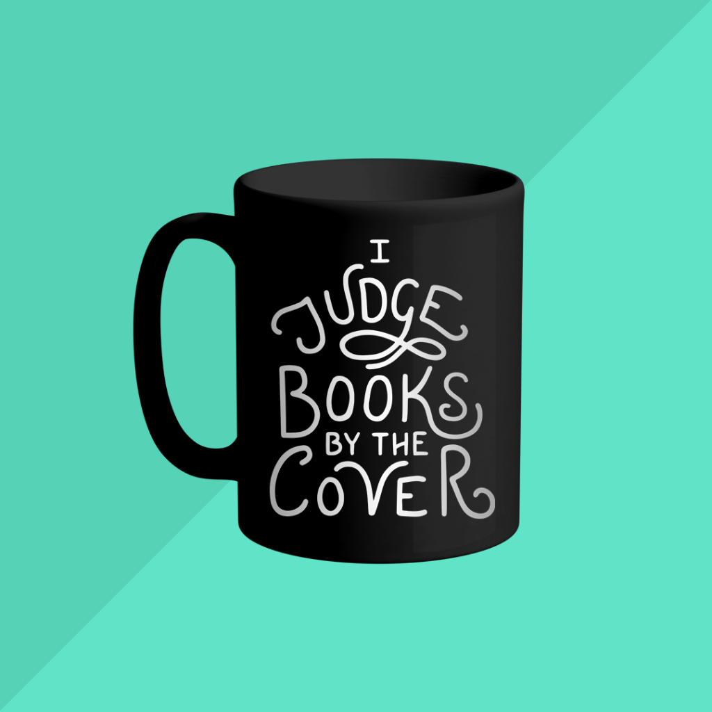 Mug mockup featuring the "I Judge Books by the Cover" hand lettered design.